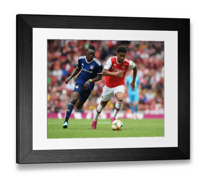 Framed Print : Arsenal's Reiss Nelson Outmaneuvers Lyon's Bertrand Traore at Emirates Cup Framed Print : Arsenal's Reiss Nelson Outmaneuvers Lyon's Bertrand Traore at Emirates Cup