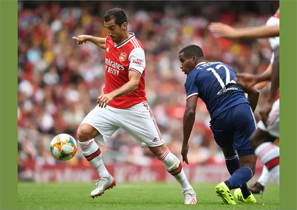 Arsenal's Mkhitaryan Outmaneuvers Lyon's Thiago Mendes in Emirates Cup Clash