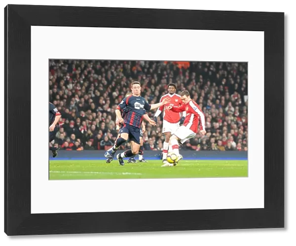 Thomas Vermaelen shoots past Bolton defender Gary Cahill to score the 3rd Arsenal goal