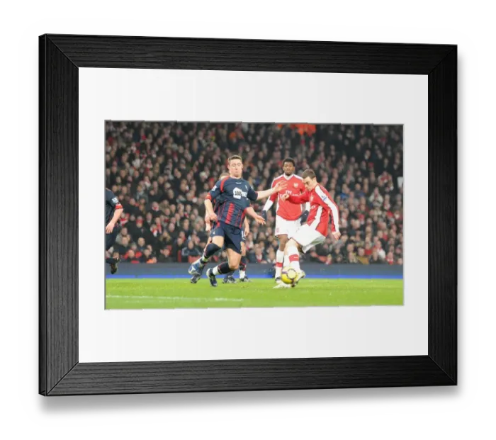Framed Print : Thomas Vermaelen shoots past Bolton defender Gary Cahill to score the 3rd Arsenal goal