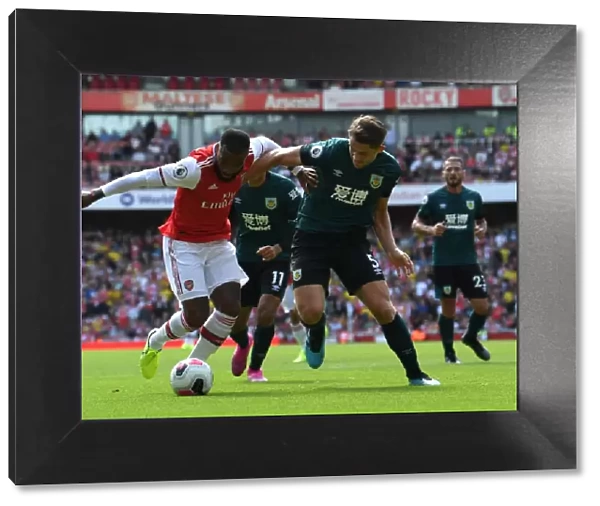 Arsenal's Lacazette Clashes with Burnley's Tarkowski in Premier League Showdown
