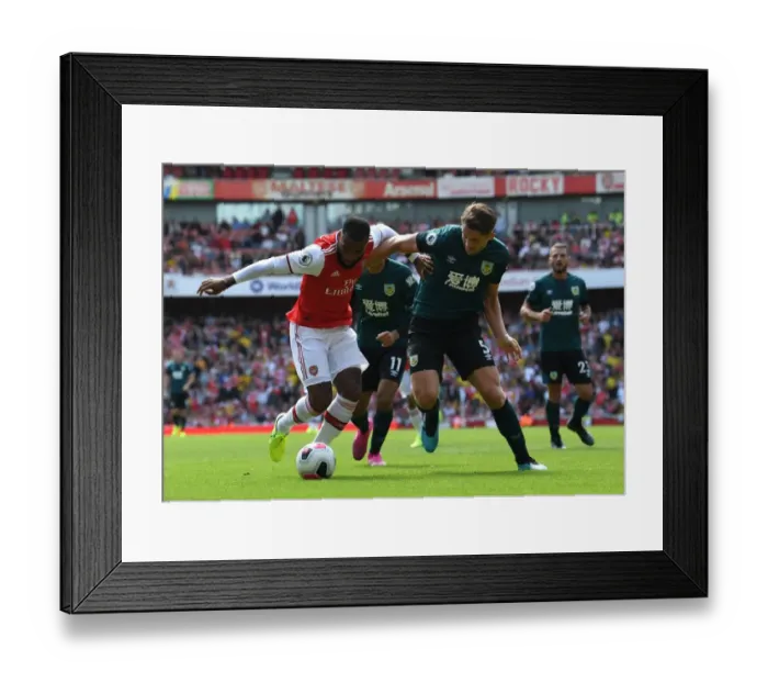 Framed Print : Arsenal's Lacazette Clashes with Burnley's Tarkowski in Premier League Showdown