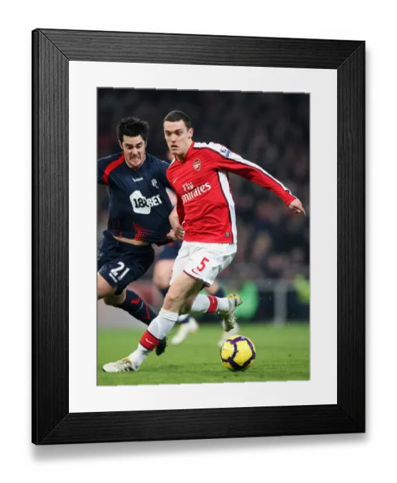 Framed Print : Thomas Vermaelen (Arsenal) holds off Tamir Cohen (Bolton). Arsenal 4: 2 Bolton Wanderers Framed Print : Thomas Vermaelen (Arsenal) holds off Tamir Cohen (Bolton). Arsenal 4: 2 Bolton Wanderers