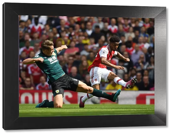Arsenal's Nelson and Tarkowski Go Head-to-Head in Intense Premier League Showdown