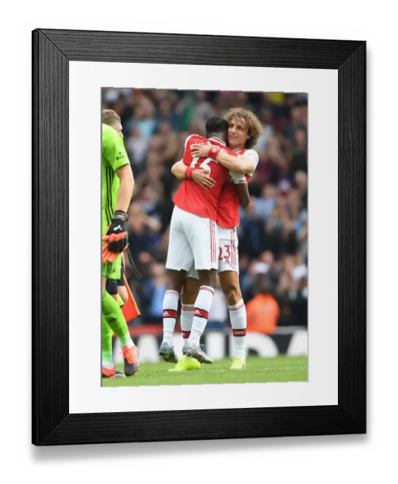 Framed Print : Arsenal's Emotional Victory: David Luiz and Ainsley Maitland-Niles Embrace Post-Match