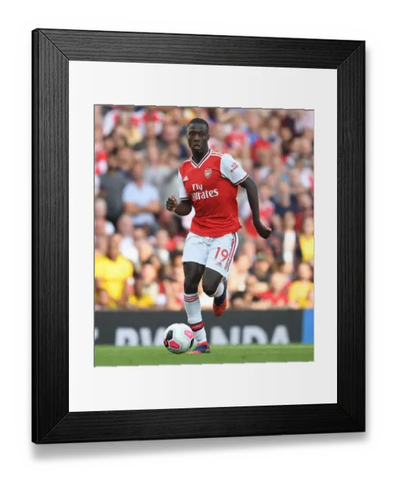 Framed Print : Arsenal's Nicolas Pepe Goes Head-to-Head with Tottenham in Premier League Battle Framed Print : Arsenal's Nicolas Pepe Goes Head-to-Head with Tottenham in Premier League Battle