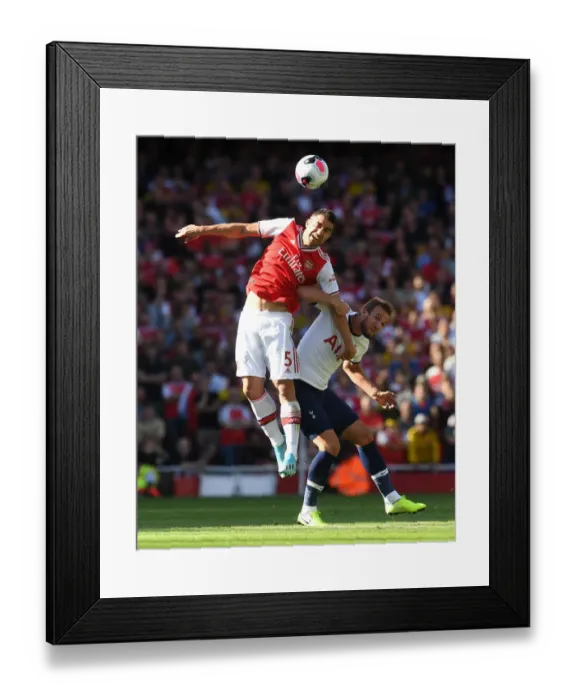 Framed Print : Arsenal vs. Tottenham: Sokratis Heads Off Harry Kane's Pressure in Intense Premier League Clash (2019-20)