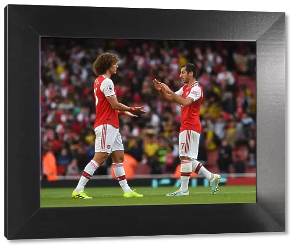 Arsenal's Victory: Mkhitaryan and David Luiz Celebrate Against Tottenham in the Premier League