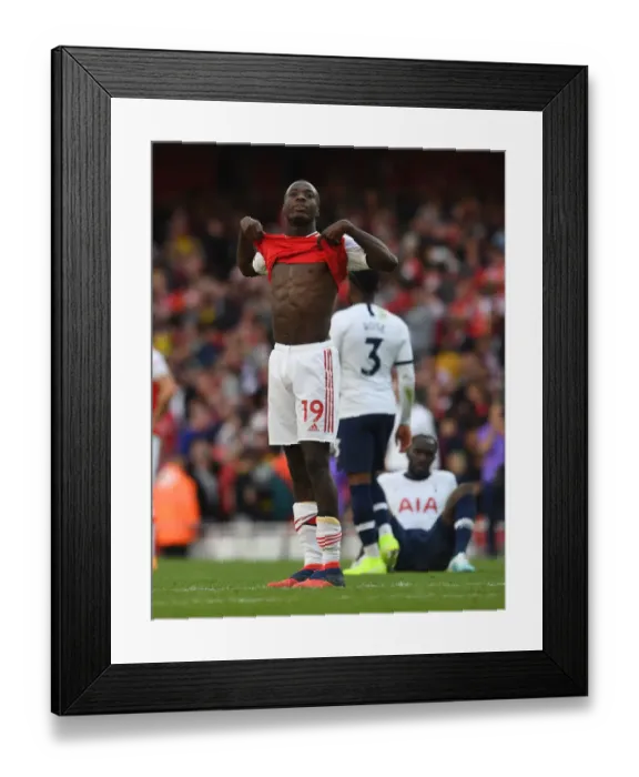 Framed Print : Arsenal's Nicolas Pepe Reacts After Arsenal FC vs. Tottenham Hotspur in the 2019-20 Premier League Framed Print : Arsenal's Nicolas Pepe Reacts After Arsenal FC vs. Tottenham Hotspur in the 2019-20 Premier League