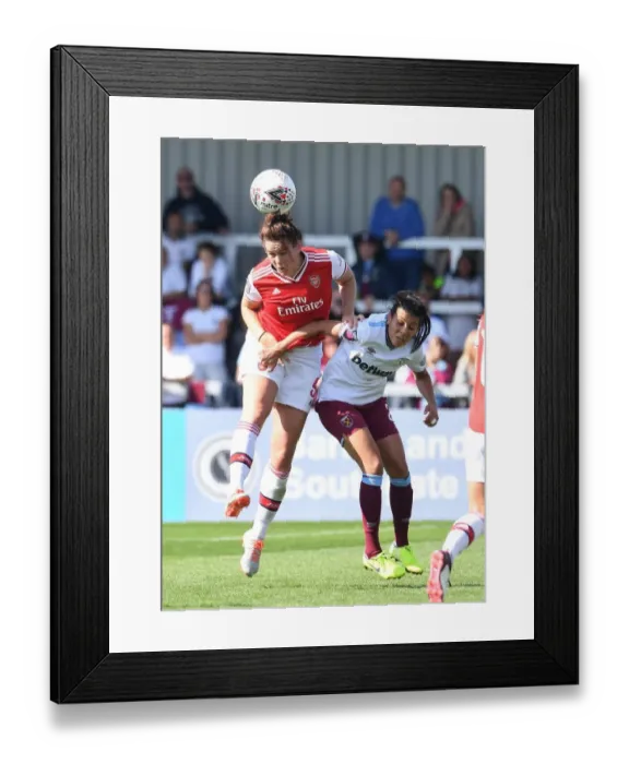 Framed Print : Arsenal vs West Ham Women: Jennifer Beattie Heads Away from Danger