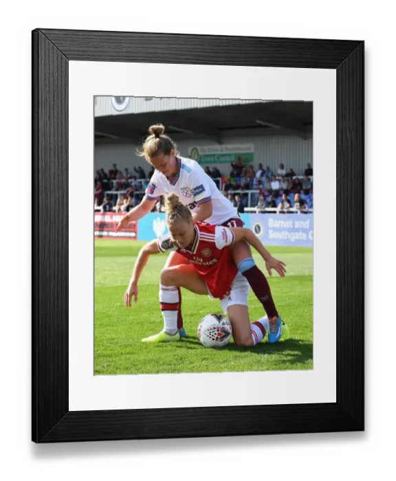 Framed Print : Arsenal vs West Ham Women's Football: Intense Battle at Meadow Park
