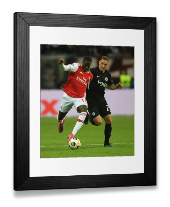 Framed Print : Pepe vs. Kohr: A Europa League Battle - Arsenal's Nicolas Pepe Goes Head-to-Head with Eintracht Frankfurt's Dominik Kohr Framed Print : Pepe vs. Kohr: A Europa League Battle - Arsenal's Nicolas Pepe Goes Head-to-Head with Eintracht Frankfurt's Dominik Kohr