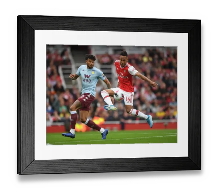 Framed Print : Arsenal's Aubameyang Faces Off Against Villa's Mings in Intense Premier League Clash