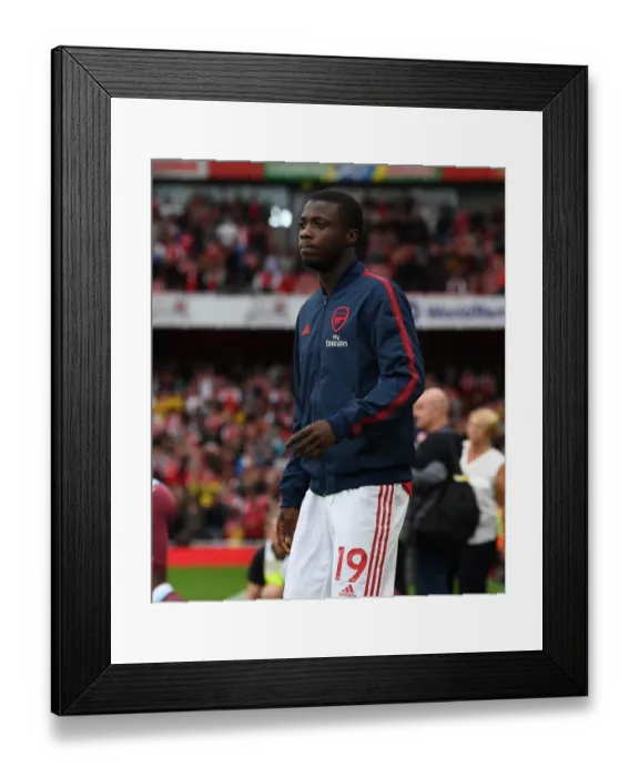 Framed Print : Arsenal's Nicolas Pepe Ready for Action Against Aston Villa (2019-20 Premier League) Framed Print : Arsenal's Nicolas Pepe Ready for Action Against Aston Villa (2019-20 Premier League)