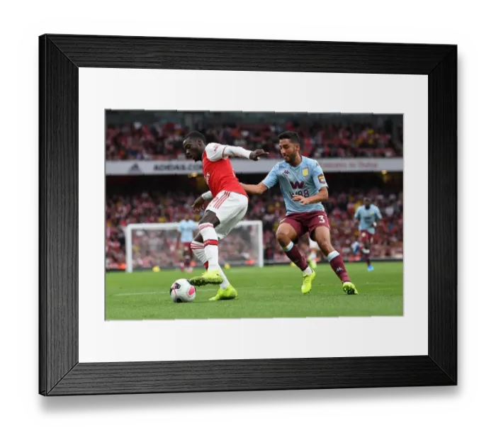 Framed Print : Arsenal's Pepe Faces Off Against Villa's Taylor in Premier League Clash Framed Print : Arsenal's Pepe Faces Off Against Villa's Taylor in Premier League Clash