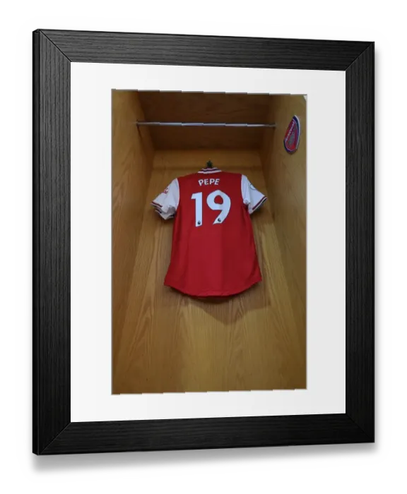 Framed Print : Arsenal's Nicolas Pepe Prepares for Aston Villa Clash in Emirates Stadium Changing Room Framed Print : Arsenal's Nicolas Pepe Prepares for Aston Villa Clash in Emirates Stadium Changing Room