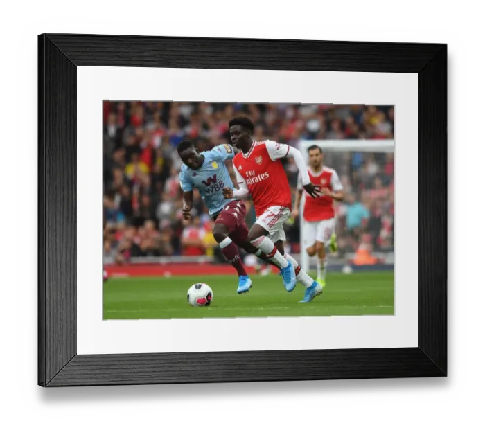 Framed Print : Arsenal's Bukayo Saka vs. Aston Villa's Marvelous Nakamba: A Premier League Battle at Emirates Stadium