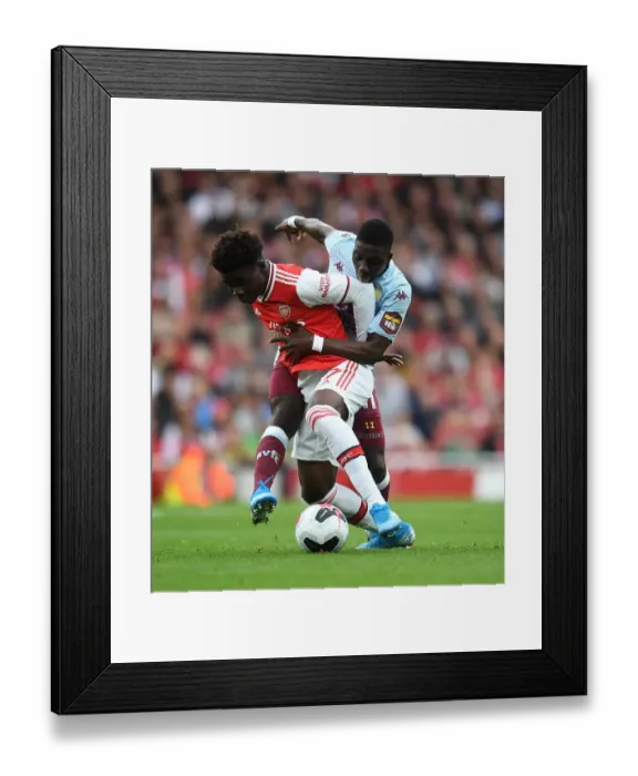 Framed Print : Arsenal vs Aston Villa: Bukayo Saka Clash with Nakamba in Premier League Showdown
