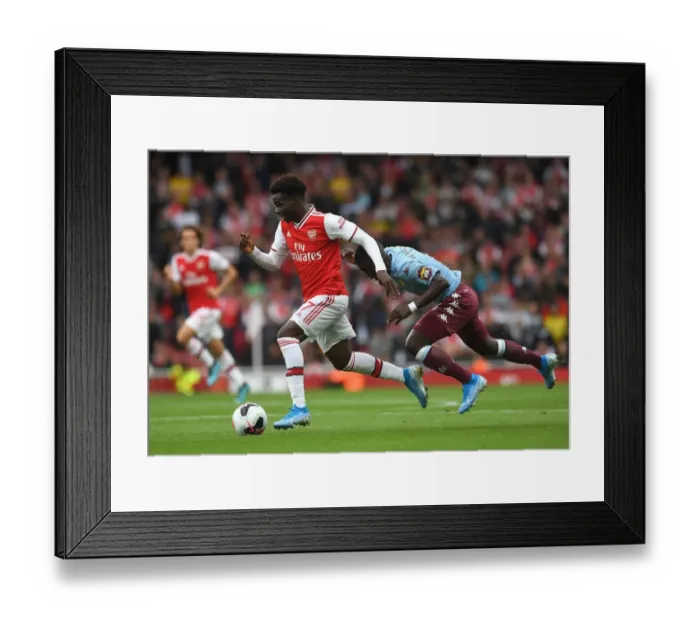 Framed Print : Saka vs. Nakamba: Intense Face-Off in Arsenal's Battle Against Aston Villa Framed Print : Saka vs. Nakamba: Intense Face-Off in Arsenal's Battle Against Aston Villa