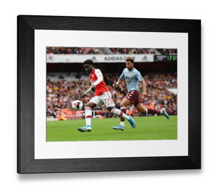 Framed Print : Saka vs. Trezeguet: A Premier League Showdown - Intense Face-Off Between Arsenal's Young Gun and Aston Villa's Midfielder Framed Print : Saka vs. Trezeguet: A Premier League Showdown - Intense Face-Off Between Arsenal's Young Gun and Aston Villa's Midfielder