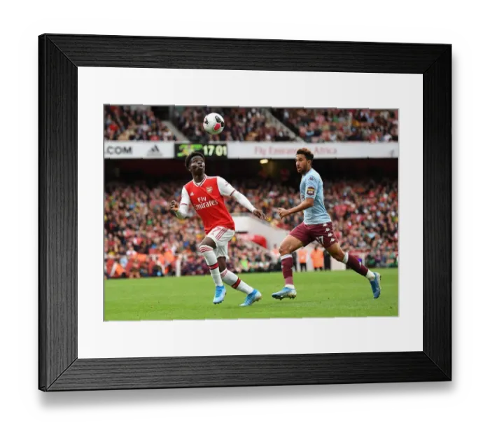 Framed Print : Arsenal's Bukayo Saka Faces Off Against Aston Villa's Trezeguet in Intense Premier League Clash Framed Print : Arsenal's Bukayo Saka Faces Off Against Aston Villa's Trezeguet in Intense Premier League Clash