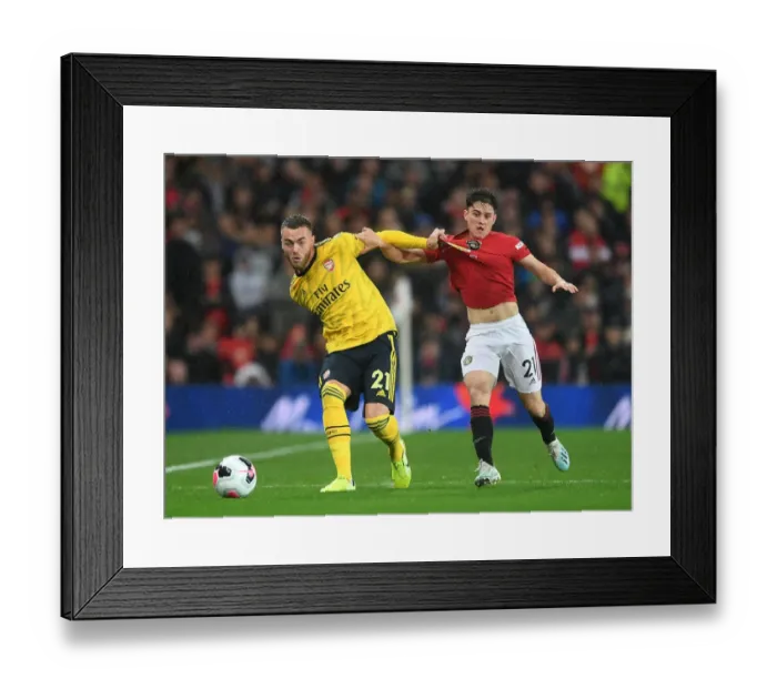 Framed Print : Calum Chambers Evades Daniel James: A Tense Moment from the Manchester United vs Arsenal Premier League Clash (2019-20)