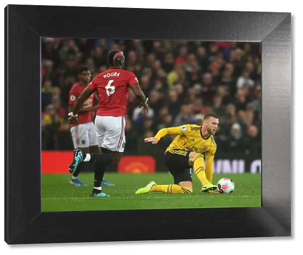 Manchester United vs Arsenal: Tense Moment as Calum Chambers Faces Off Against Paul Pogba in the Premier League