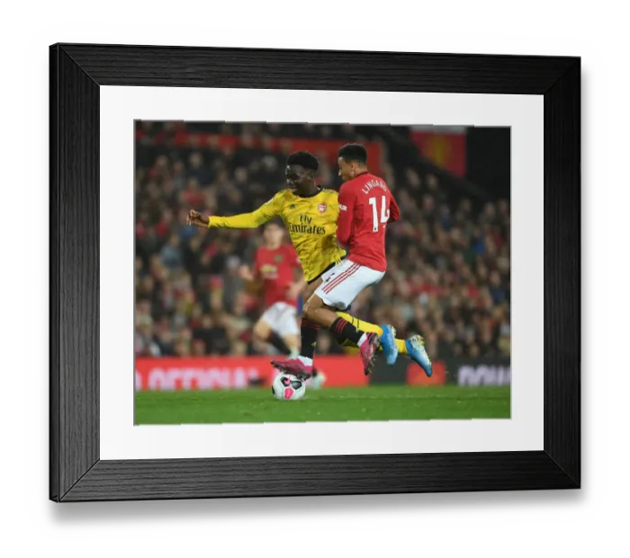 Framed Print : Clash of the Red and Blues: Bukayo Saka vs Ashley Young - Battle at Old Trafford (Manchester United vs Arsenal 2019-20)