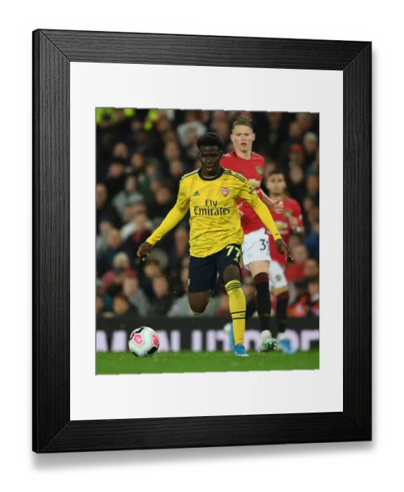 Framed Print : Bukayo Saka Dashes Past McTominay: Manchester United vs. Arsenal, Premier League 2019-20