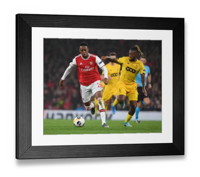 Framed Print : Arsenal's Joe Willock Scores Past Standard Liege's Kostas Laifis in Europa League Clash Framed Print : Arsenal's Joe Willock Scores Past Standard Liege's Kostas Laifis in Europa League Clash
