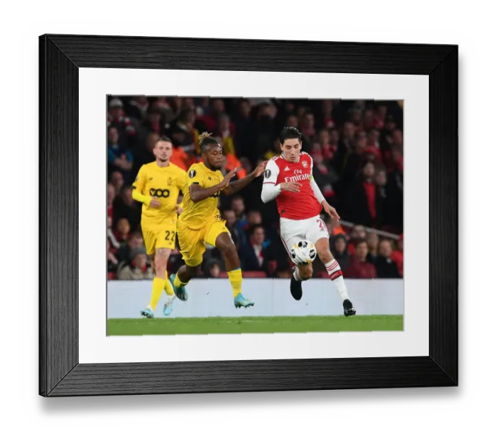Framed Print : Arsenal's Hector Bellerin Clashes with Standard Liege's Samuel Bastien in Europa League Match