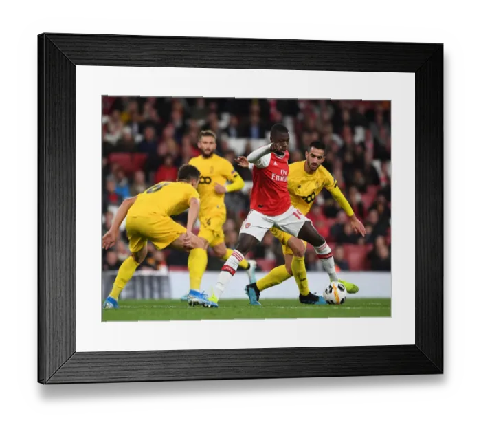 Framed Print : Arsenal's Pepe Goes Head-to-Head with Standard Liege's Cimirot in Europa League Showdown Framed Print : Arsenal's Pepe Goes Head-to-Head with Standard Liege's Cimirot in Europa League Showdown
