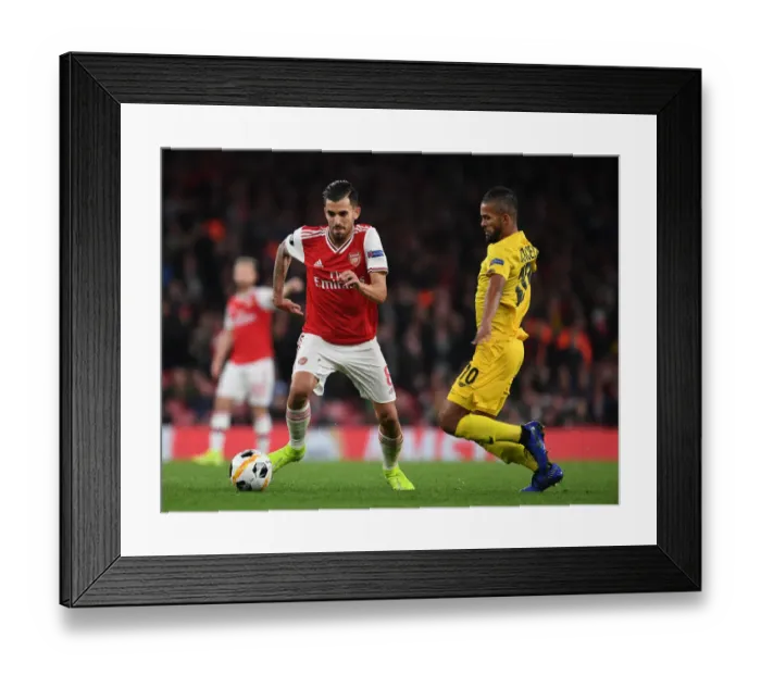 Framed Print : Arsenal's Dani Ceballos Breaks Past Standard Liege's Mehdi Carcela in Europa League Clash