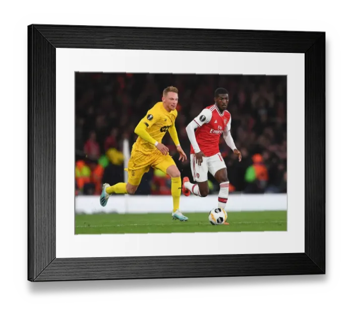 Framed Print : Arsenal's Ainsley Maitland-Niles Goes Head-to-Head with Renaud Emond in Europa League Showdown