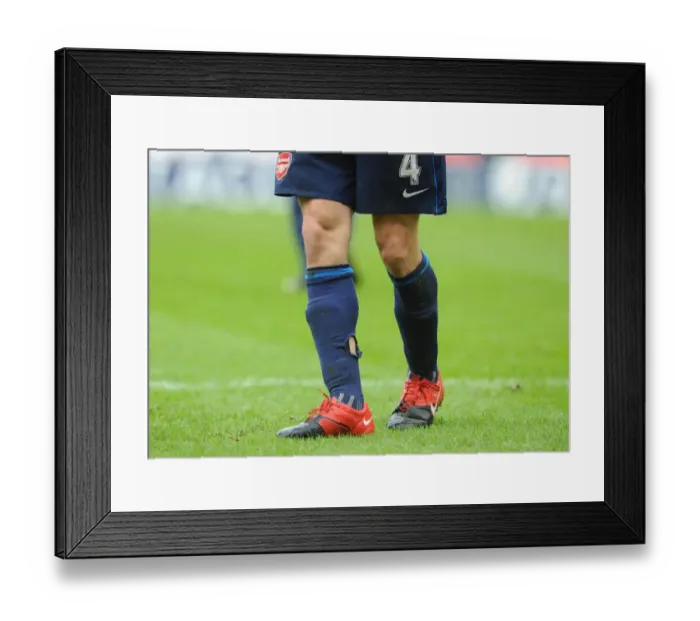 Framed Print : Arsenal captain Cesc Fabregas socks after a challenge from a Stoke player