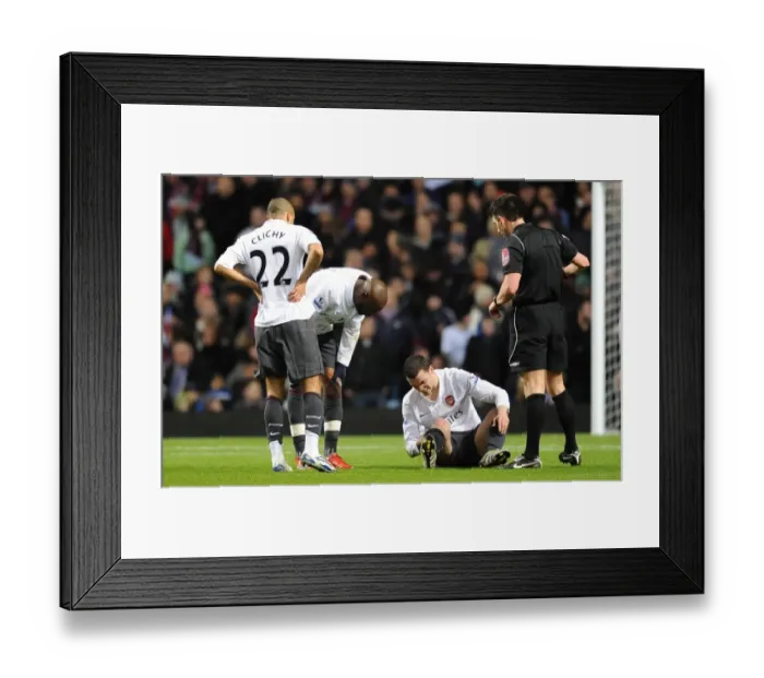 Framed Print : Thomas Vermaelen sits injuryed on the pitch as Gael Clichy and William Gallas Framed Print : Thomas Vermaelen sits injuryed on the pitch as Gael Clichy and William Gallas
