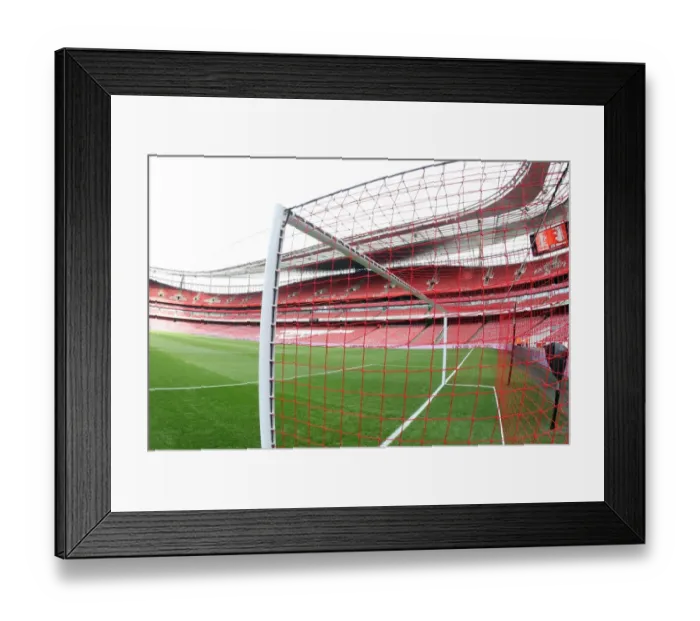 Framed Print : Arsenal's Red Nike Goalnets: Lace Up Save Lives in Action during Manchester United Match