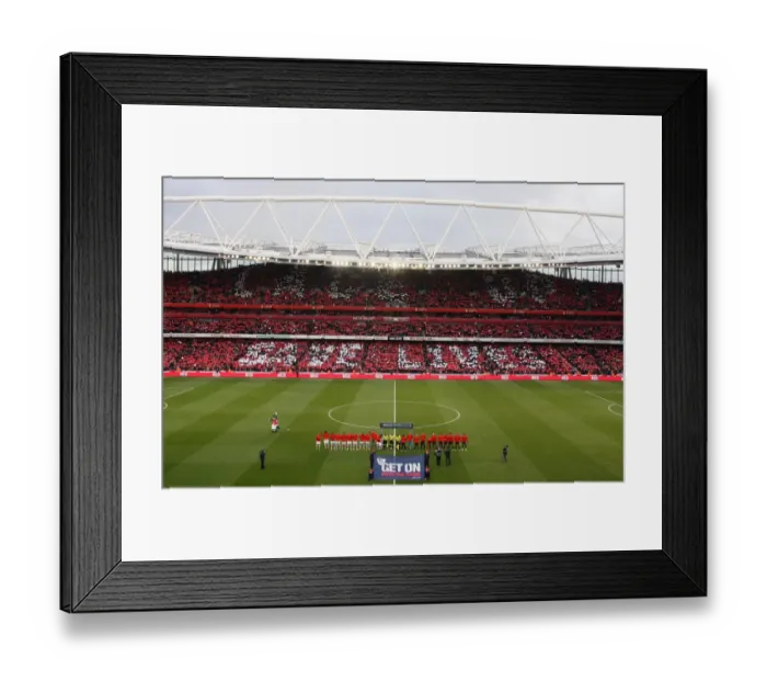 Framed Print : The Arsenal and Manchester United teams walk out onto the pitch with the Nike Lace Up Save Lives cards held up be the fans. Arsenal 1: 3 Manchester United. Barclays Premier League. Emirates Stadium, 31  /  1  /  10. Credit : Arsenal Football Club
