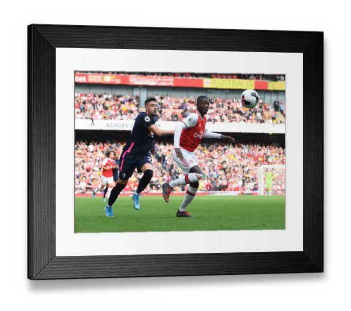 Framed Print : Arsenal's Nicolas Pepe Outmaneuvers Bournemouth's Diego Rico in Premier League Clash