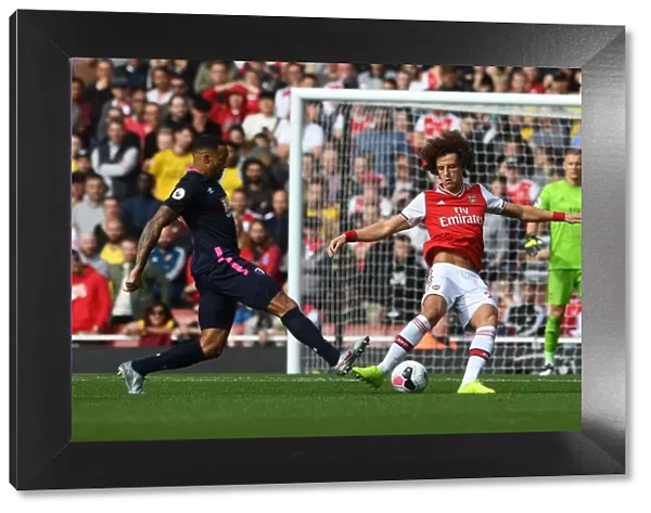 Arsenal's David Luiz Evades Pressure from Bournemouth's Callum Wilson During Premier League Clash