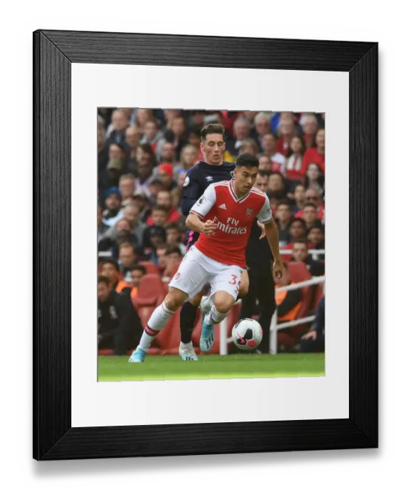 Framed Print : Arsenal's Martinelli Clashes with Bournemouth's Wilson in Premier League Showdown