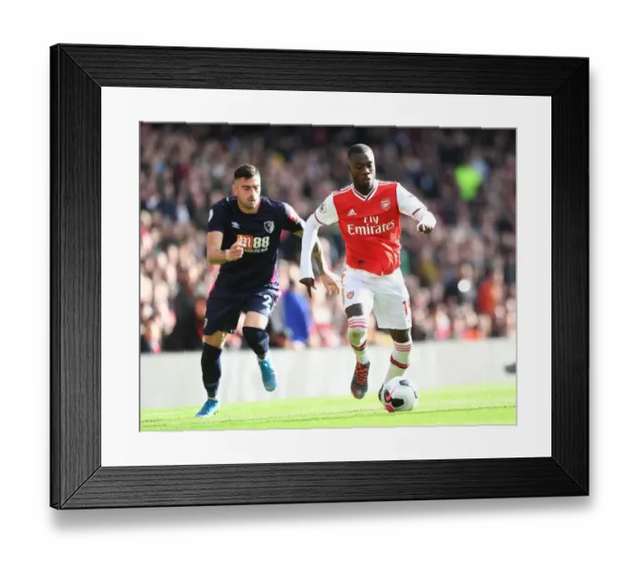 Framed Print : Arsenal's Nicolas Pepe Clashes with Bournemouth's Diego Rico in Premier League Showdown