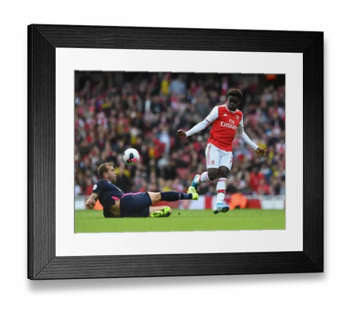 Framed Print : Arsenal's Bukayo Saka Faces Off Against Bournemouth's Steve Cook in Premier League Clash