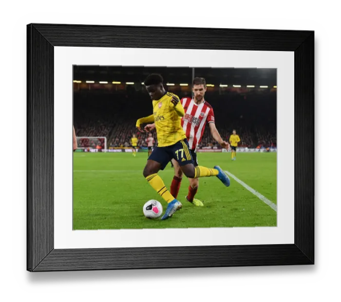 Framed Print : Bukayo Saka Dashes Past Chris Basham: Sheffield United vs. Arsenal, Premier League 2019-20 Framed Print : Bukayo Saka Dashes Past Chris Basham: Sheffield United vs. Arsenal, Premier League 2019-20