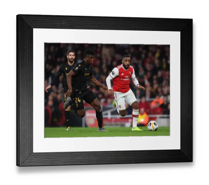 Framed Print : Arsenal's Lacazette Faces Off Against Vitoria's Mikel Agu in Europa League Clash Framed Print : Arsenal's Lacazette Faces Off Against Vitoria's Mikel Agu in Europa League Clash
