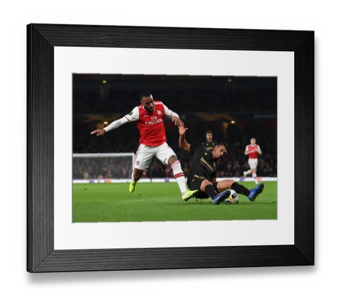 Framed Print : Arsenal vs. Vitoria Guimaraes: Lacazette Tackled in Europa League Clash Framed Print : Arsenal vs. Vitoria Guimaraes: Lacazette Tackled in Europa League Clash