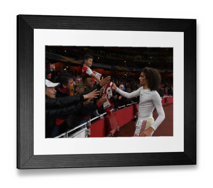 Framed Print : Arsenal's Guendouzi Gifts Shirt to Fan after Europa League Victory over Vitoria Guimaraes