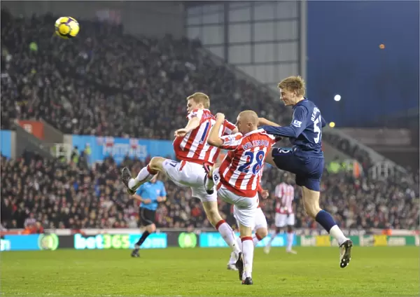 Nicklas Bendtner heads past Ryan Shawcross and Andy Wilkinson to score the 1st Arsenal goal