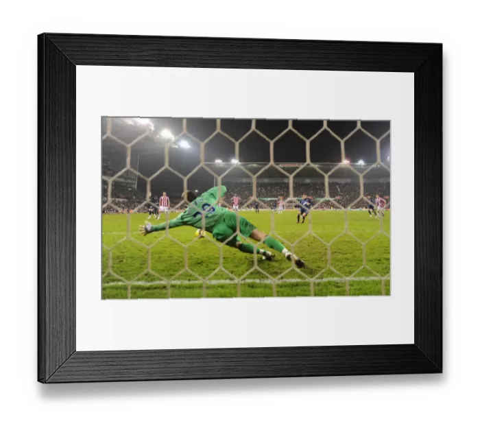 Framed Print : Cesc Fabregas shoots past Stoke goalkeeper Thomas Sorensen from the penalty spot to score the 2nd Arsenal goal. Stoke City 1: 3 Arsenal, Barclays Premier League, The Britanna Stadium, Stoke, 27  /  2  /  2010. Credit : Stuart MacFarlane  / 