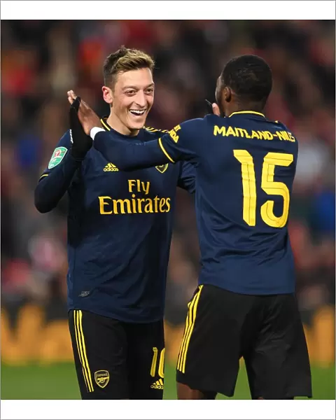 Arsenal's Four-Goal Rampage: Ozil and Maitland-Niles Celebrate at Anfield